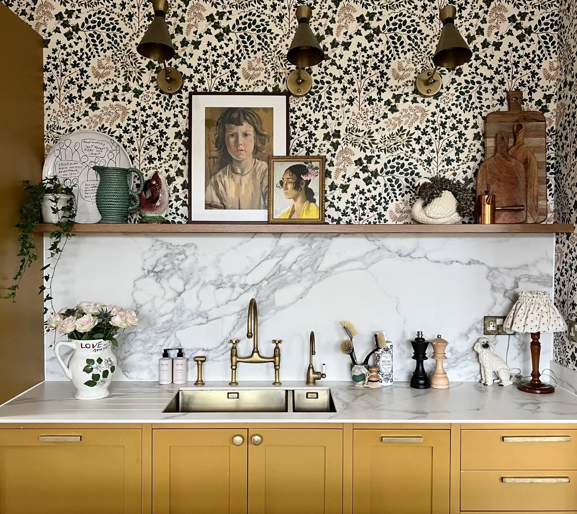 White marble countertop with gold sink and faucet.